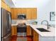 Modern kitchen featuring stainless steel appliances, wood cabinets, and a bright breakfast bar at 115 E Park Ave # 428, Charlotte, NC 28203
