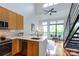 Open living space featuring modern kitchen, staircase, ceiling fan, and bright windows with a view at 115 E Park Ave # 428, Charlotte, NC 28203