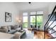 Inviting living room with modern decor, large windows, and access to a balcony at 115 E Park Ave # 428, Charlotte, NC 28203