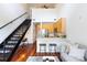 Bright living room with stainless steel appliances, modern cabinets, and a loft staircase at 115 E Park Ave # 428, Charlotte, NC 28203
