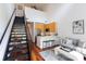 Bright living room with stainless steel appliances, modern cabinets, and a loft staircase at 115 E Park Ave # 428, Charlotte, NC 28203