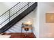 Home office area located under a staircase with a modern desk and decor at 115 E Park Ave # 428, Charlotte, NC 28203