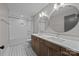 Well-lit bathroom with a double vanity, large mirrors, and a bathtub with white subway tile at 1207 Lakedell Dr, Charlotte, NC 28215