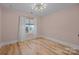 Calm bedroom featuring a neutral color palette, hardwood floors, and a window with sheer curtains at 1207 Lakedell Dr, Charlotte, NC 28215