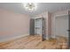 Stylish bedroom with hardwood floors, gray walls, an open closet and ensuite bathroom at 1207 Lakedell Dr, Charlotte, NC 28215