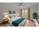 Comfortable bedroom with a queen bed, stylish decor, hardwood floors, and natural light from the window at 1207 Lakedell Dr, Charlotte, NC 28215
