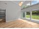 Bright bedroom featuring hardwood floors, modern lighting, and large windows overlooking the backyard at 1207 Lakedell Dr, Charlotte, NC 28215