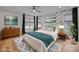 Bright staged bedroom featuring hardwood floors, modern decor, and plenty of natural light at 1207 Lakedell Dr, Charlotte, NC 28215