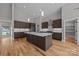 Island kitchen featuring wooden cabinets, a white countertop island, and pendant lighting fixtures at 1207 Lakedell Dr, Charlotte, NC 28215