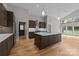 Spacious kitchen boasting custom cabinetry, stainless appliances, and a large central island with bar seating at 1207 Lakedell Dr, Charlotte, NC 28215