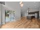 Open-concept space with hardwood floors, sliding glass doors, and a kitchen island with stainless steel appliances at 1207 Lakedell Dr, Charlotte, NC 28215