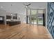 Open-concept living area with wood floors, tall ceilings, large windows, and access to the backyard at 1207 Lakedell Dr, Charlotte, NC 28215