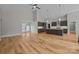 Beautiful open concept living area showcasing hard wood floors, high ceilings, and a modern kitchen at 1207 Lakedell Dr, Charlotte, NC 28215