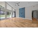Open-concept living room showcasing hardwood flooring, tall ceilings, a statement wall, and large windows at 1207 Lakedell Dr, Charlotte, NC 28215