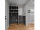 Office nook featuring custom shelving, natural light, and hardwood floors at 1207 Lakedell Dr, Charlotte, NC 28215