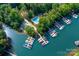 Stunning aerial view featuring boat slips, a community pool and lush landscaping at 122 Waterford Dr, Mooresville, NC 28117