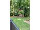 Exterior view of backyard from deck with hanging flower baskets and green grass at 122 Waterford Dr, Mooresville, NC 28117