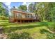 Brick home with a large deck and lush backyard, perfect for outdoor activities and entertaining at 122 Waterford Dr, Mooresville, NC 28117