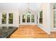 Sunlit breakfast nook with large windows, hardwood floors and views of the wooded back yard at 122 Waterford Dr, Mooresville, NC 28117
