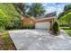 A long concrete driveway leads to a spacious two-car garage, with an established lawn with mature shrubbery at 122 Waterford Dr, Mooresville, NC 28117