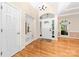 Bright foyer with hardwood floors, a chandelier, and a transom window above the front door at 122 Waterford Dr, Mooresville, NC 28117
