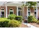 Charming brick home featuring a covered front porch with arched windows and well-maintained landscaping at 122 Waterford Dr, Mooresville, NC 28117