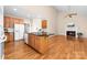 Open kitchen and breakfast nook featuring hardwood floors, center island and easy access to the living room at 122 Waterford Dr, Mooresville, NC 28117