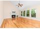 Spacious living room with a cozy fireplace, hardwood floors, large windows with natural light at 122 Waterford Dr, Mooresville, NC 28117