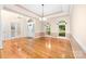 Open-concept living area with hardwood floors and lots of natural light, ideal for entertaining at 122 Waterford Dr, Mooresville, NC 28117