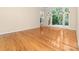 Bright living room with hardwood floors and a large window showcasing the outdoor view at 122 Waterford Dr, Mooresville, NC 28117
