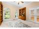 Cozy office space with built-in bookshelves, carpet, and natural light from a large window at 122 Waterford Dr, Mooresville, NC 28117