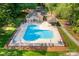 Aerial view of a community pool and clubhouse, surrounded by lush landscaping and lounge chairs at 122 Waterford Dr, Mooresville, NC 28117