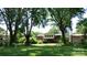 Lush backyard with mature trees, offering a private and serene outdoor space at 1245 Paddock Cir, Charlotte, NC 28209