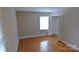 A bedroom with hardwood floors, a built in closet, and natural light at 1245 Paddock Cir, Charlotte, NC 28209