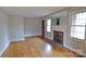 Bright living room boasting gleaming hardwood floors and a cozy brick fireplace at 1245 Paddock Cir, Charlotte, NC 28209