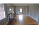 An empty living room featuring hardwood floors and a fireplace with a decorative mantel at 1245 Paddock Cir, Charlotte, NC 28209
