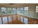 Hardwood floors gleam in the sunroom with ample natural light and access to the backyard at 1245 Paddock Cir, Charlotte, NC 28209