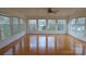 Sunroom awash in natural light, featuring hardwood floors, with walls of windows at 1245 Paddock Cir, Charlotte, NC 28209
