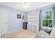 Blue bedroom with a ceiling fan, window, and light neutral carpet, perfect for relaxation and comfort at 125 Canopy Ct, Mooresville, NC 28115