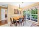 Eat-in kitchen with a wooden dining table, black leather chairs, and bright natural light at 125 Canopy Ct, Mooresville, NC 28115