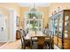Dining area with a large window, hardwood floors, and elegant display cabinet at 125 Canopy Ct, Mooresville, NC 28115