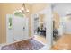 Bright foyer with white pillars, chandelier, and view of the dining room at 125 Canopy Ct, Mooresville, NC 28115