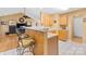 Kitchen with breakfast bar seating, light wood cabinets, and tile flooring for a casual dining space at 125 Canopy Ct, Mooresville, NC 28115