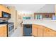 The kitchen features a gas range, black dishwasher, and a view into the dining area, enhancing openness at 125 Canopy Ct, Mooresville, NC 28115