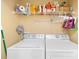 Functional laundry room with a wire shelf above side-by-side washer and dryer for organized storage at 125 Canopy Ct, Mooresville, NC 28115