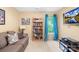 Cozy living room with a bookcase, comfortable seating, and a bright window with blue curtains at 125 Canopy Ct, Mooresville, NC 28115