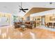 Spacious living room with hardwood floors, ceiling fan, and open layout to the kitchen at 125 Canopy Ct, Mooresville, NC 28115