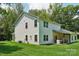 Well-maintained backyard with a lush lawn, mature trees, and partially covered patio at 127 Wickersham Dr, Statesville, NC 28625
