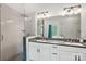 Bathroom features a double sink vanity with white cabinets and shower with glass door at 127 Wickersham Dr, Statesville, NC 28625