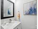 Bathroom features a framed mirror above a sink and vanity, as well as neutral wall art at 127 Wickersham Dr, Statesville, NC 28625
